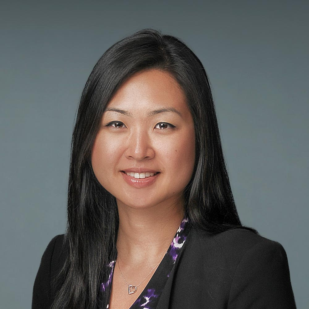 an asian woman in a black jacket