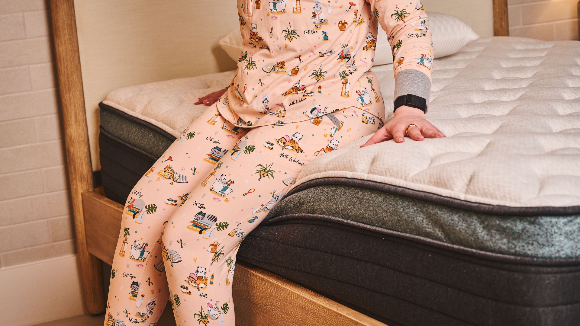 Our lead tester sits on the edge of the Helix Sunset luxe mattress during an edge support test