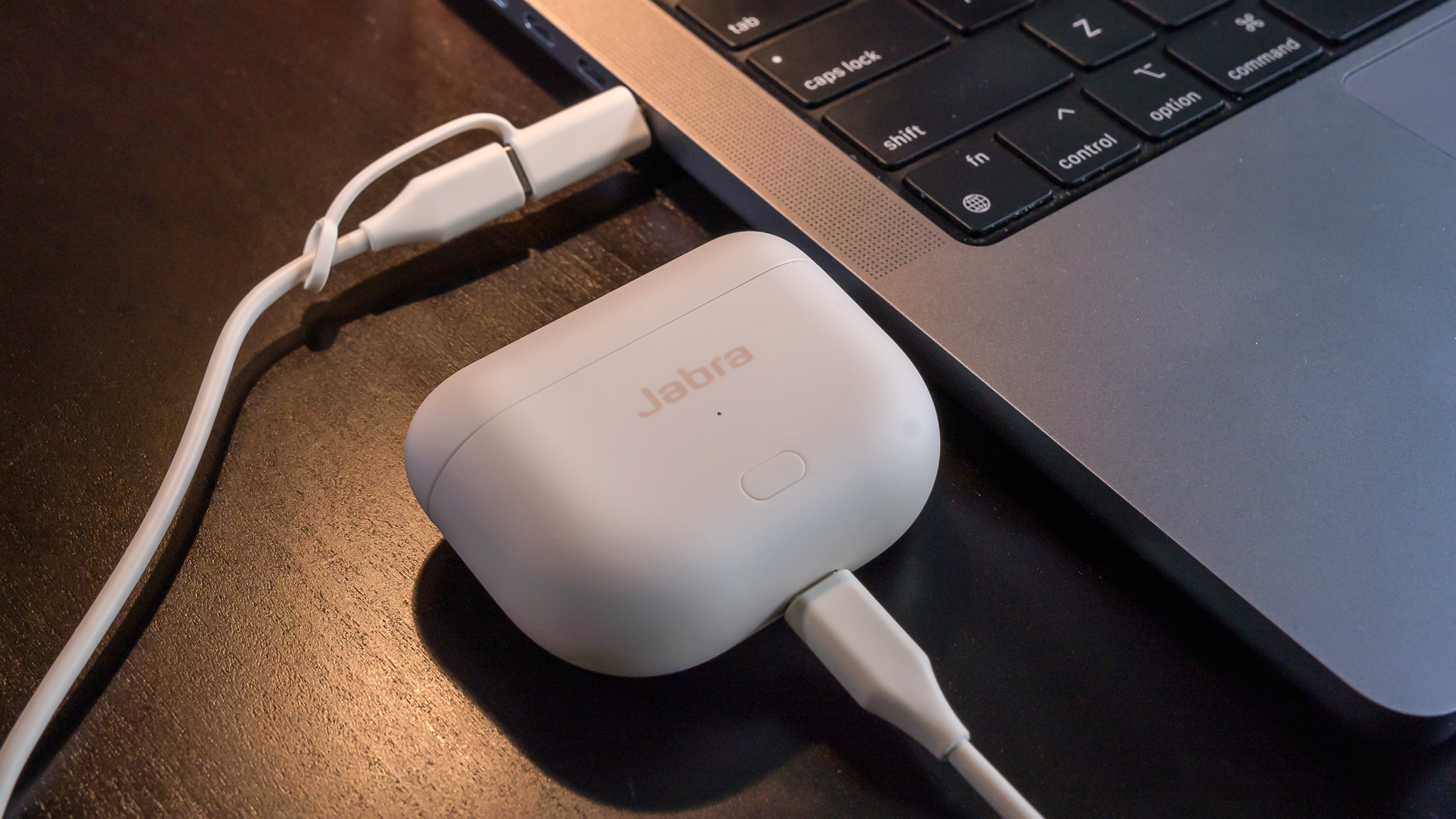 Jabra Elite 10 Gen 2 case plugged into MacBook laptop.