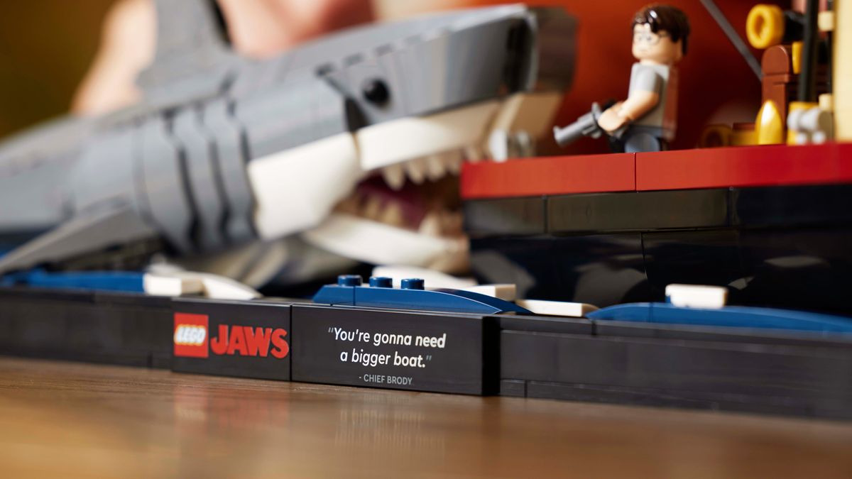 A close-up of the assembled LEGO Ideas Jaws set, showing the plaque bearing the &#039;We&#039;re gonna need a bigger boat&#039; quote