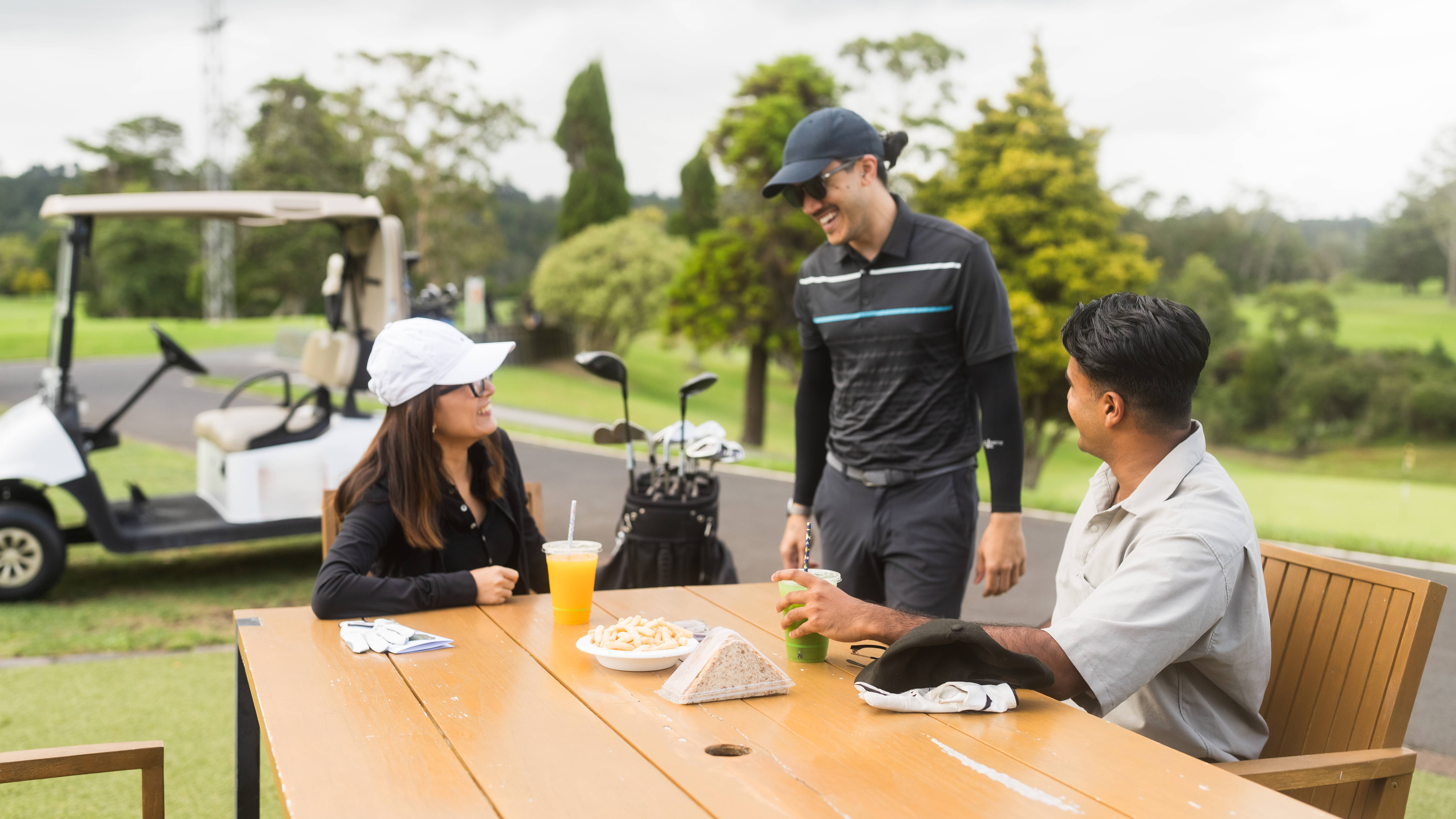 Golfers relaxing with food and drink