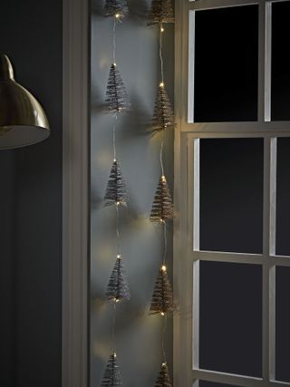 Christmas tree fairy lights in window