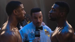 Michael B. Jordan and Jonathan Majors standing face to face in the ring in Creed III.