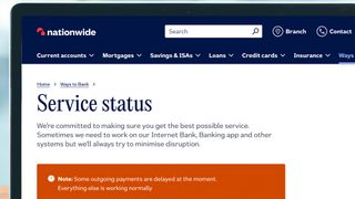 A laptop screen showing the Nationwide service status page showing issues