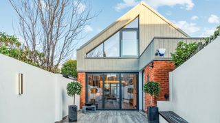 modern house with loft conversion with glazed gable end and bi-folding doors on ground floor below