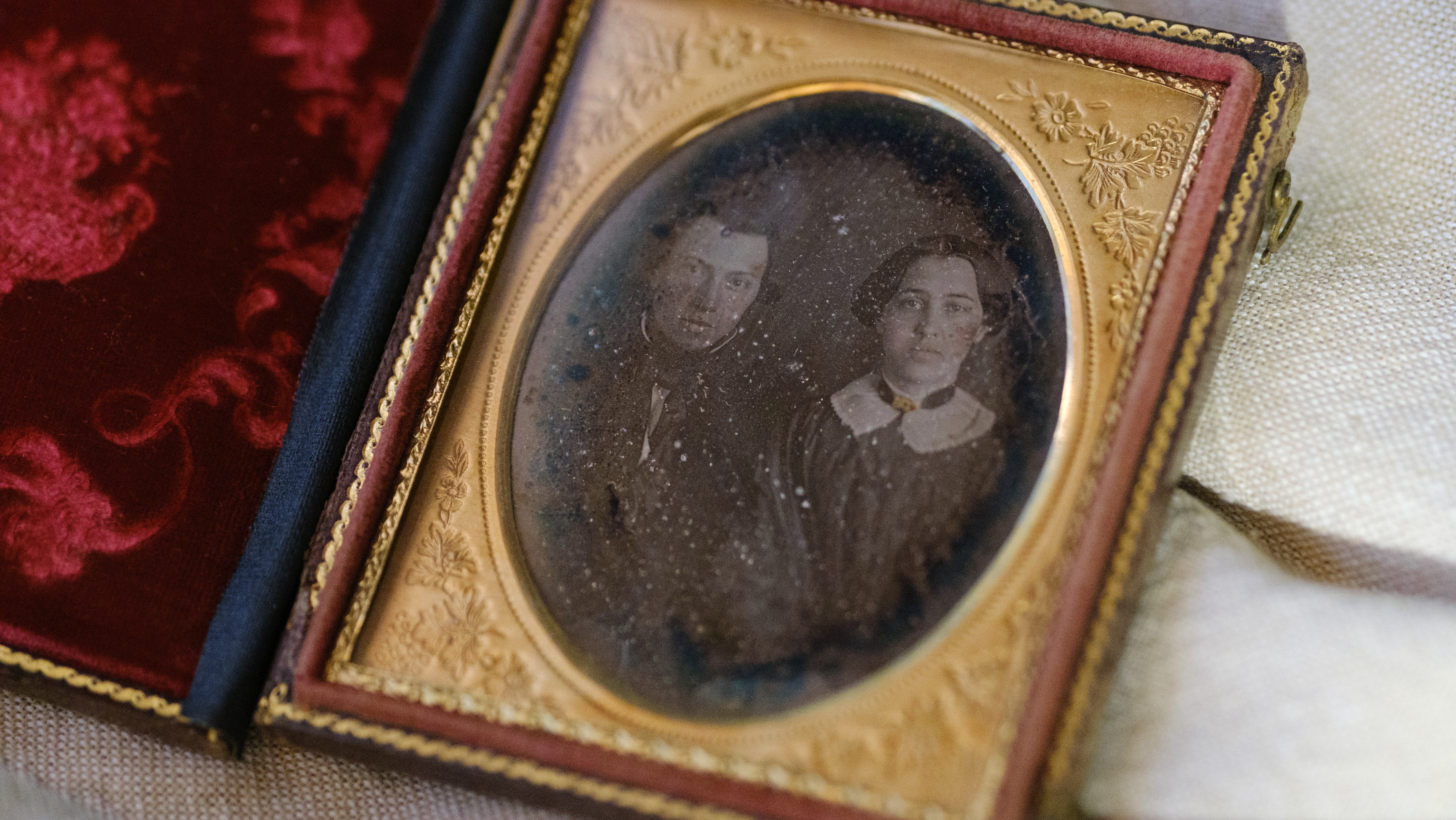 A daguerreotype on an off-white fabric background