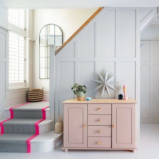 grey panelled hallway with staircase