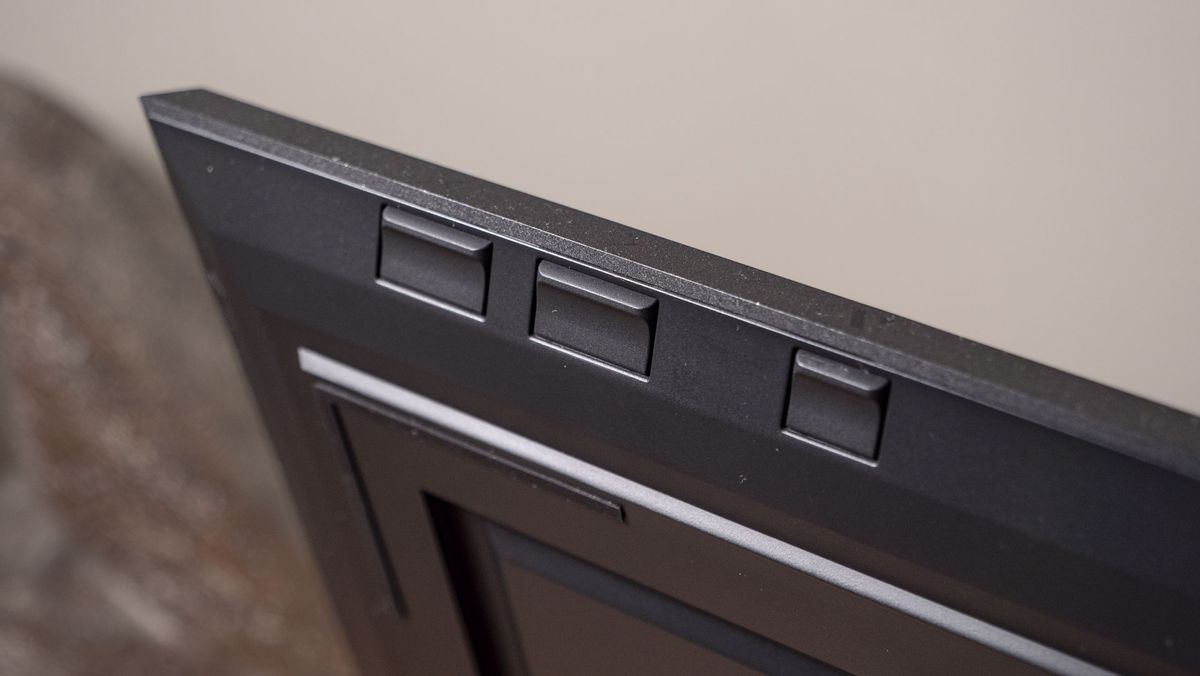 A close up of the The Aura Ink 'E Ink' digital photo frame's three control buttons