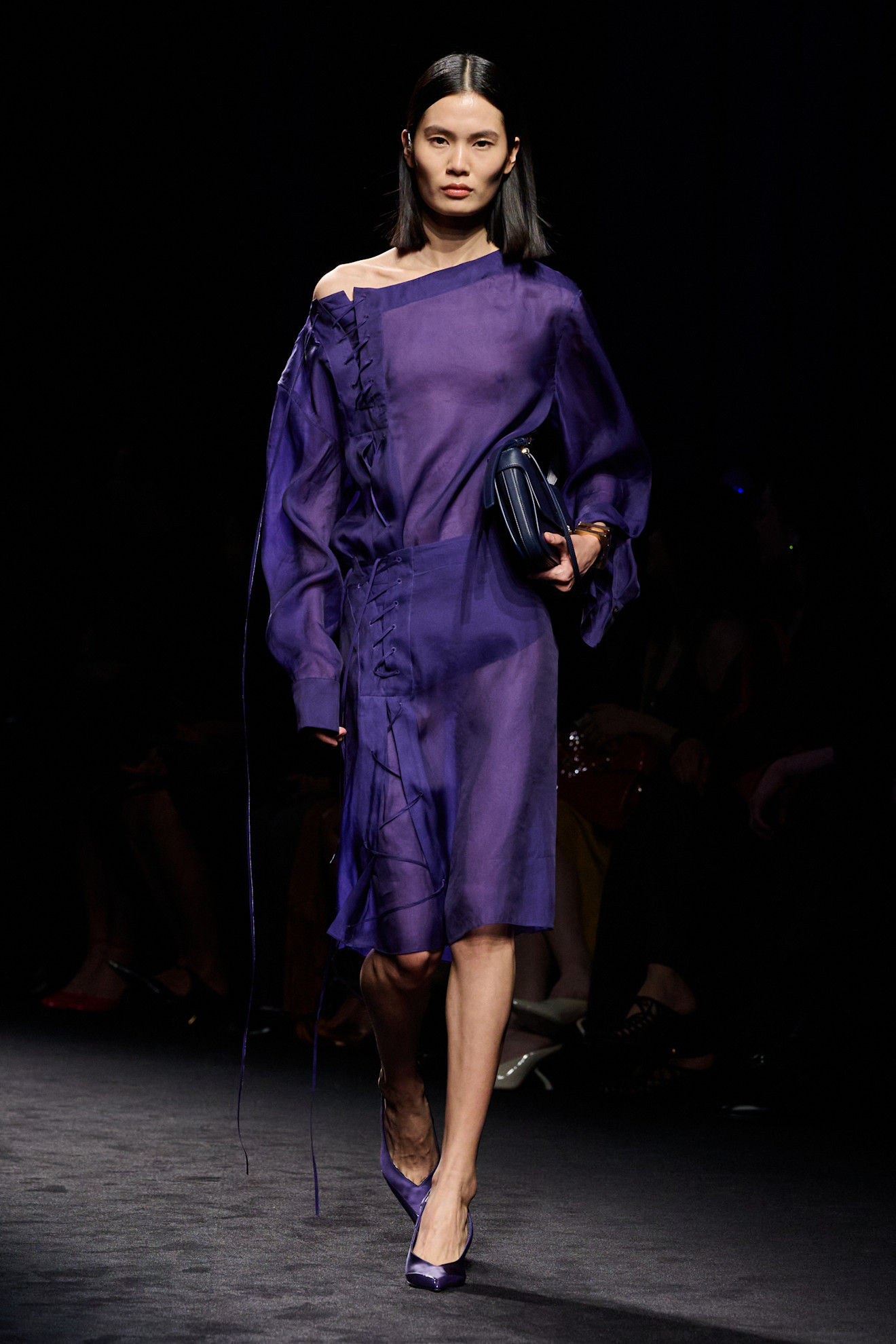 Model wears dark purple on the AW26 runway.