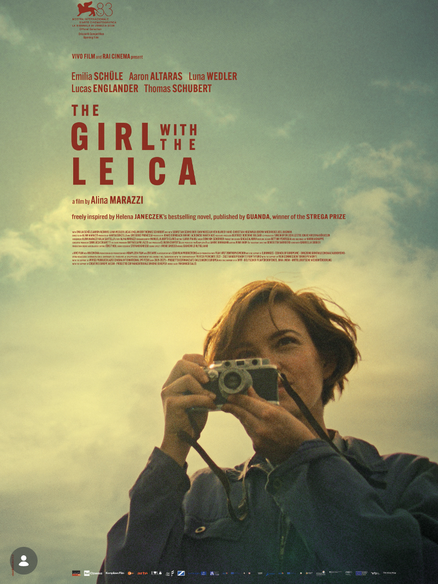 A film poster showing a woman smiling as she looks through a vintage camera against a cloudy sky, with the title "The Girl With The Leica" above her.