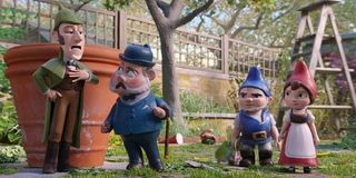 Sherlock Gnomes Sherlock and Watson beside Gnomeo and Juliet in the garden