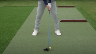 Face on photograph of a golfer addressing a driver demonstrating how much loft is on the face