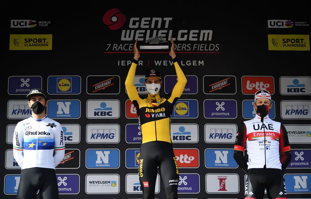 WEVELGEM BELGIUM MARCH 28 Podium Giacomo Nizzolo of Italy and Team Qhubeka Assos Wout Van Aert of Belgium and Team Jumbo Visma Matteo Trentin of Italy and UAE Team Emirates Celebration during the 83rd GentWevelgem in Flanders Fields 2021 Mens Elite a 254km race from Ypres to Wevelgem Trophy Celebration Mask Covid Safety Measures GWE21 GWEmen FlandersClassic on March 28 2021 in Wevelgem Belgium Photo by Tim de WaeleGetty Images