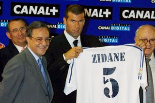 Zinedine Zidane holding the number 5 shirt alongside Florentino Perez after signing for Real Madrid from Juventus in 2001.