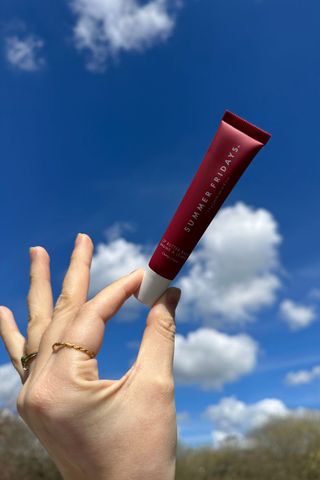Summer Fridays Lip Butter Balm held up to the sky