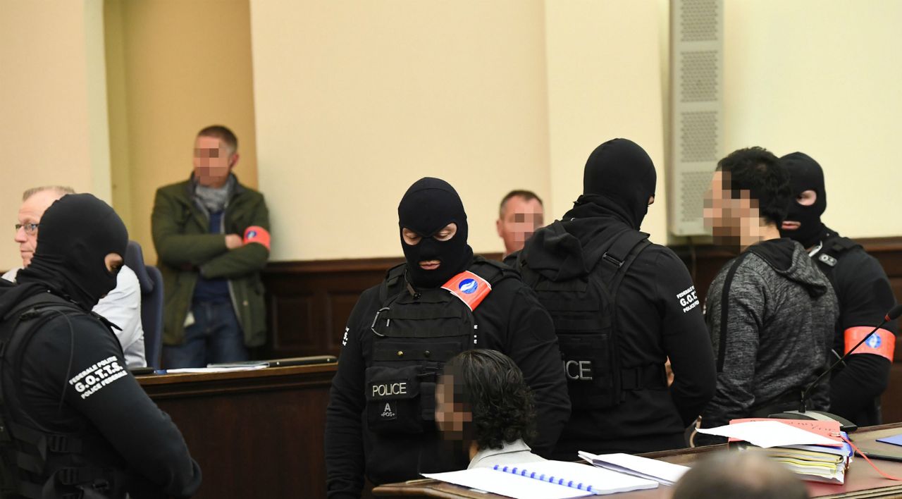 Salah Abdeslam (bottom centre) appears in a Belgian court alongside his alleged accomplice Sofiane Ayari (second from right)