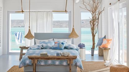 Coastal style bedroom with white bedding and driftwood finishes