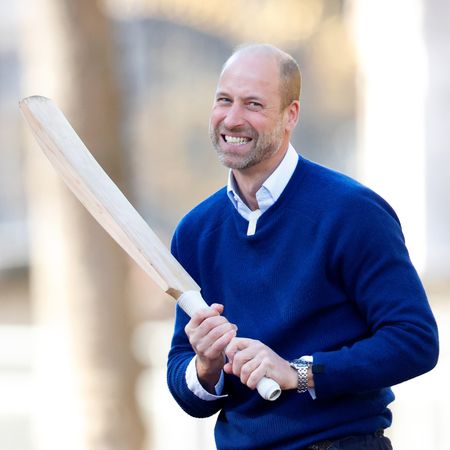 Prince William holding a cricket bat