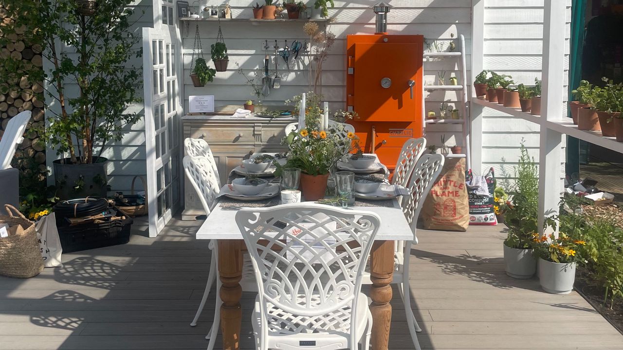 A pretty seating area underneath a pergola made out of windows