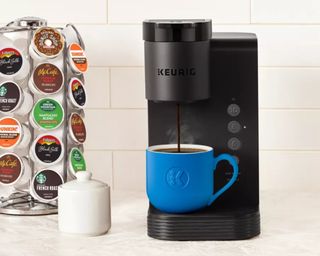 Keurig coffee maker and stand of coffee pods