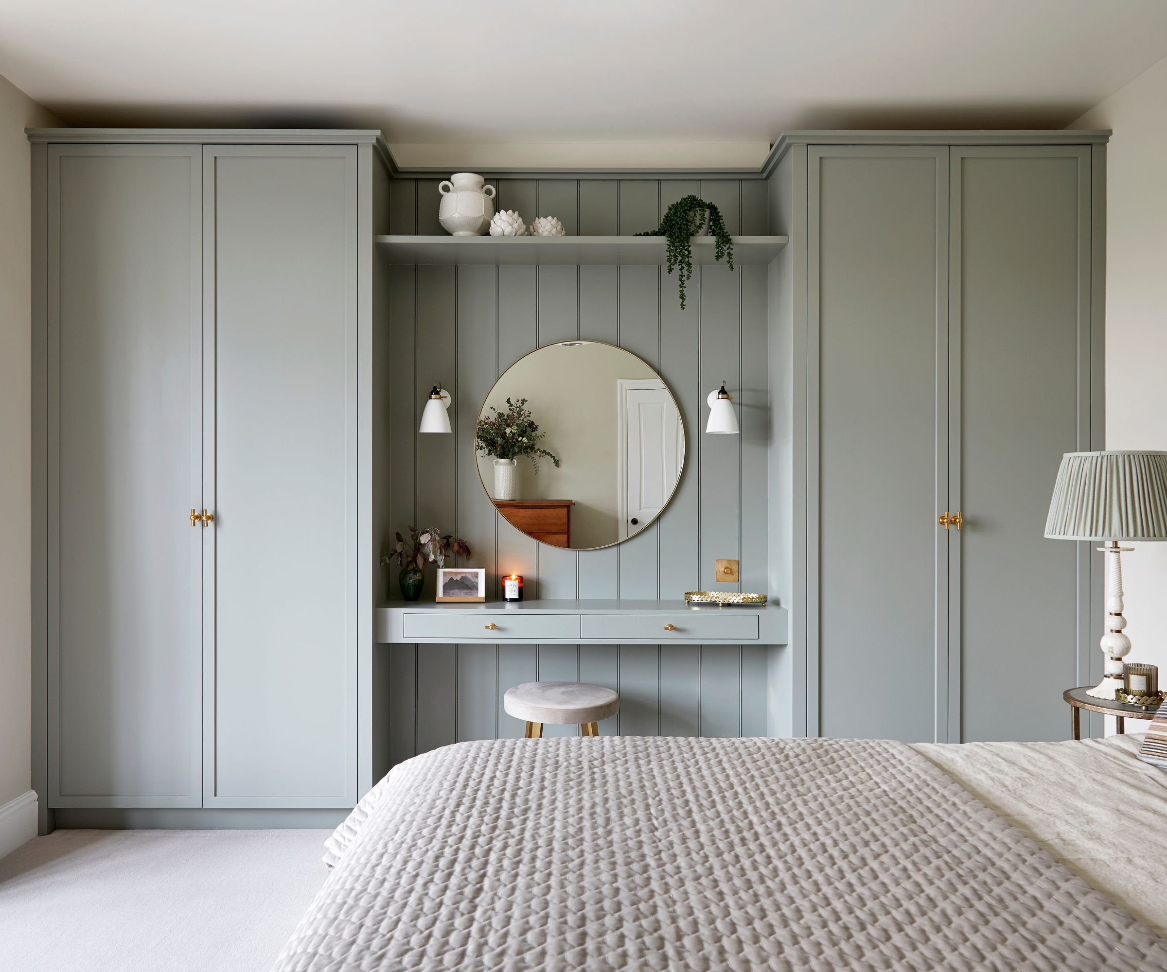 Bedroom with built-in wardrobes and vanity painted in light grey paint with cream carpet