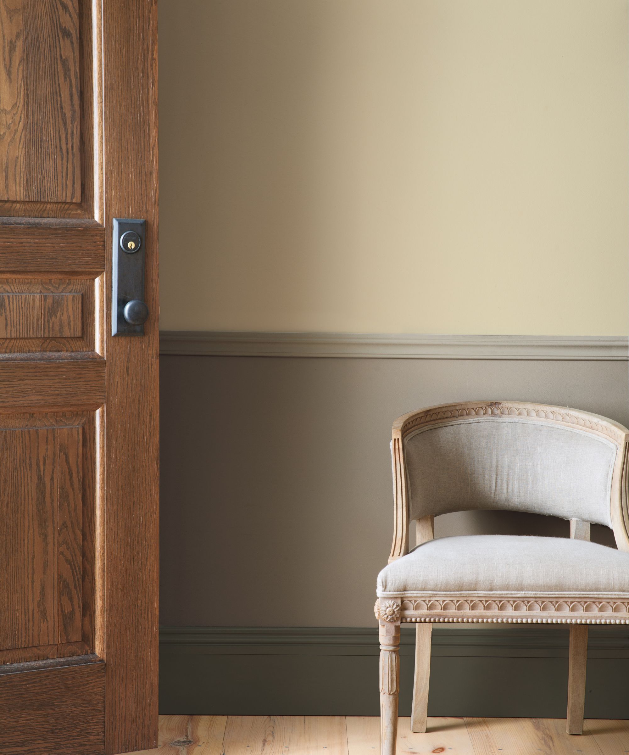 beige two-tone wall and seat next to wooden door