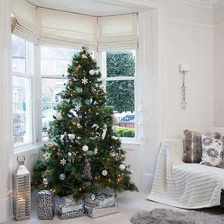 living room with white wall christmas tree and white window