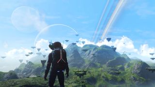 Screenshot from the space video game No Man's Sky. An astronaut looks off into the distance at a beautiful mountain landscape, complete with blue skies and a pretty rainbow.