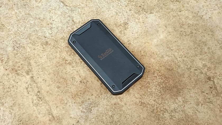 A black SanDisk Professional Pro-G40 SSD sitting on hard ground