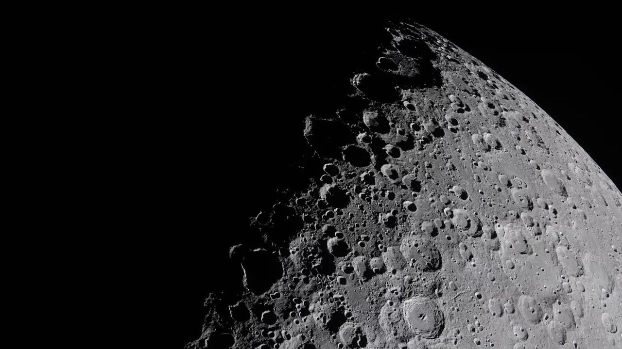 The moon's face divided sharply between light and shadow.