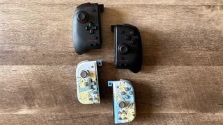 Hori Split Pad Pro vs Hori Split Pad Compact controllers on a wooden table