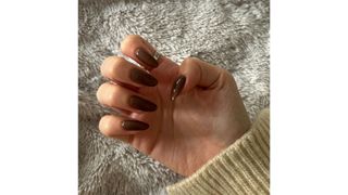 A close-up of Digital Beauty Writer, Sennen Prickett's brown almond nails