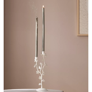 white floral candelabra holding two candles