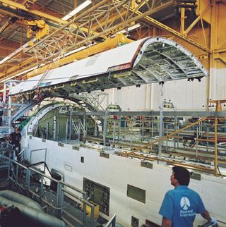 This image shows the payload bay doors being installed in the Rockwell Palmdale facility on September 9, 1990.