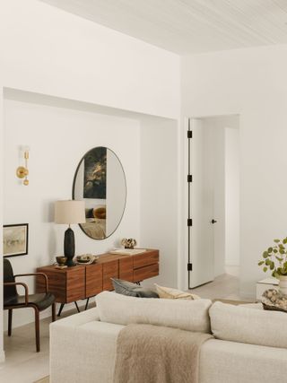 a modern white living room with a sideboard