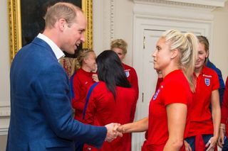 Prince William shaking hands with a footballer from the Lionesses