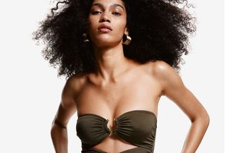 Woman wearing H&M olive green strappy one-piece swimsuit