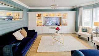 white built-in units housing a centrally located, wall-mounted TV