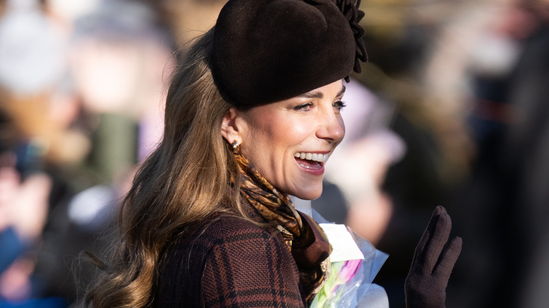 Kate Middleton wearing a plaid coat and brown hat on Christmas Day in Sandringham 2025