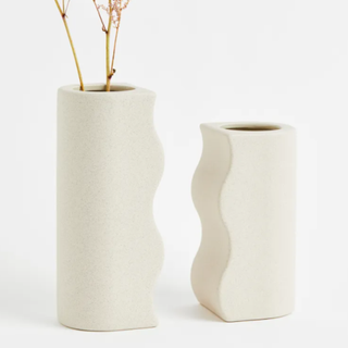 Two beige vases that fit together