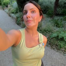 A woman in Italy taking a selfie in the sunshine with glowing skin