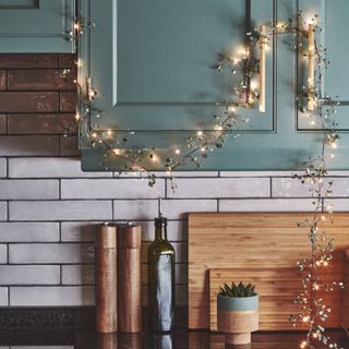 kitchen cupboards with a string of fairy lights