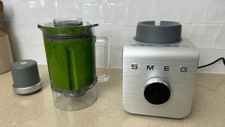 Smeg professional blender with a green smoothie in the jug