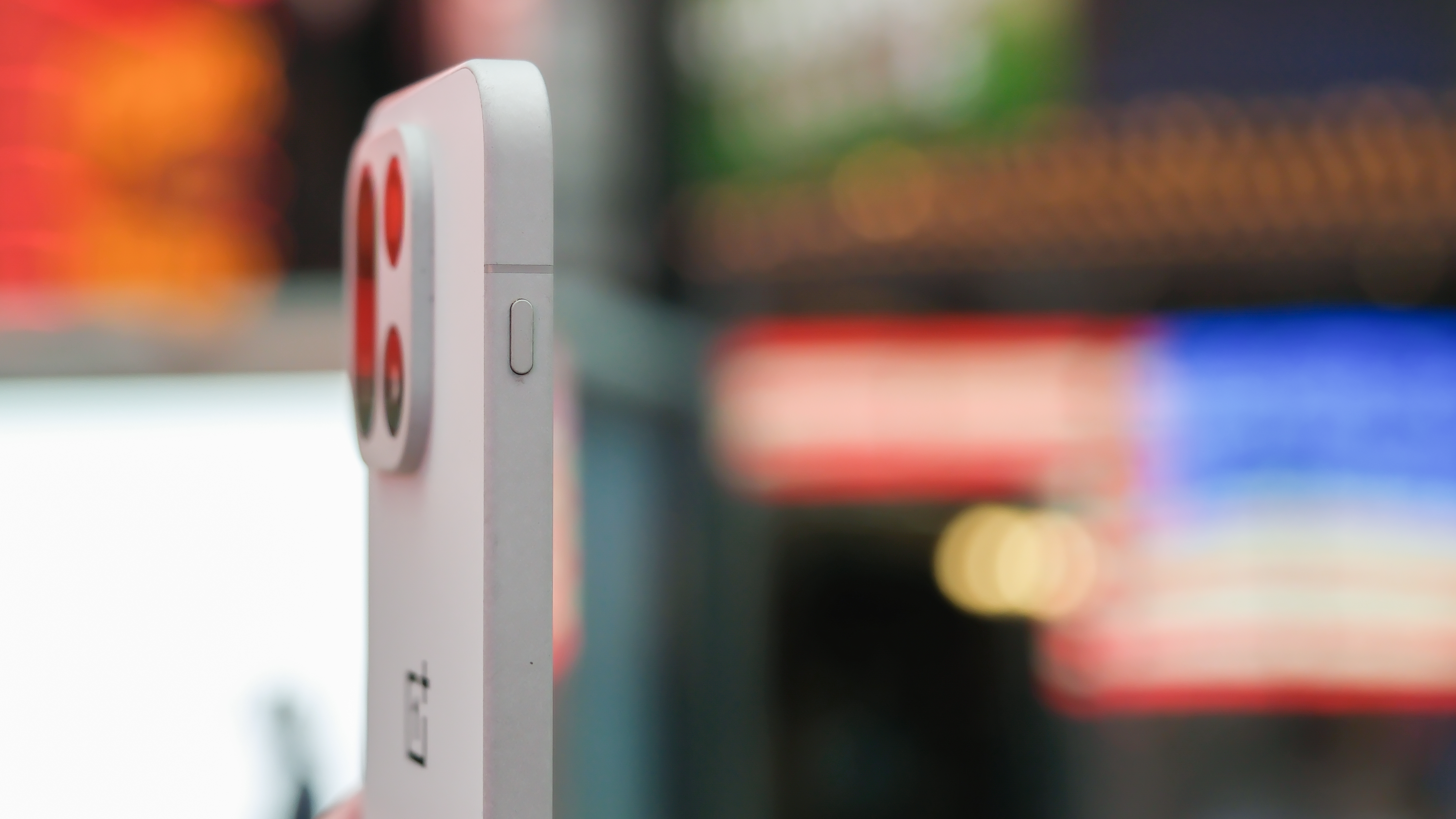 OnePlus 15 in Times Square New York City on the busy street showing the cameras and sides of the phone in addition to home screen panels and Settings menus