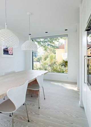 Dining area with white walls and statement lights