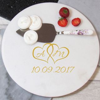white marble board with strawberry and cake server