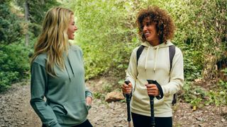 cycling vs walking - two women chatting on a hike