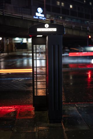 Long exposure image of a black telephone box, with car lights streaking in the background, taken on the Leica SL3-S with a Leica Summilux SL 50mm f/1.4 Asph lens