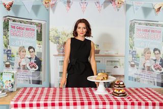 The Great British Bake Off winner Candice Brown standing at a table