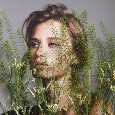 An image of a woman's face with wild flowers collaged over the top